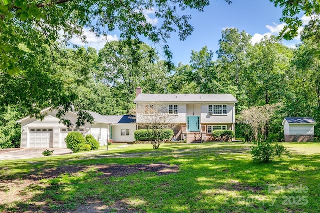 679 Fairforest Rd, Chester, SC 29706 - split foyer home with brick siding, concrete driveway, a garage, a front lawn, and a chimney