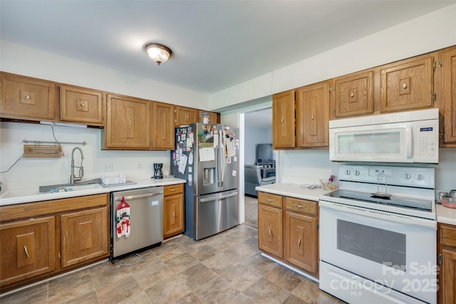 679 Fairforest Rd, Chester, SC 29706 - kitchen featuring brown cabinetry, light countertops, appliances with stainless steel finishes, and a sink