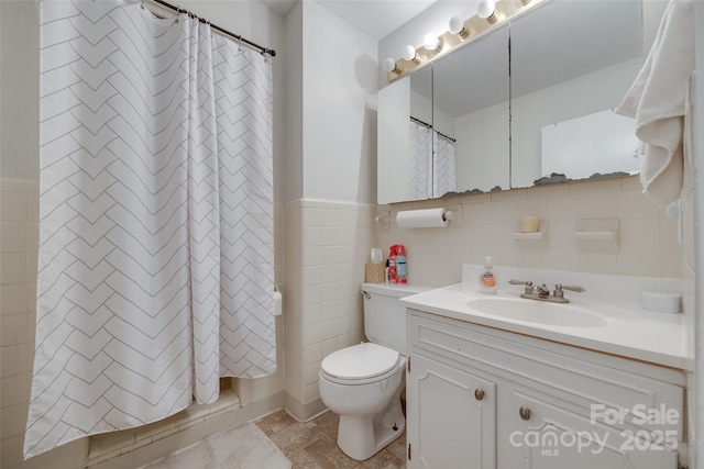 679 Fairforest Rd, Chester, SC 29706 - bathroom with tile walls, toilet, wainscoting, curtained shower, and vanity