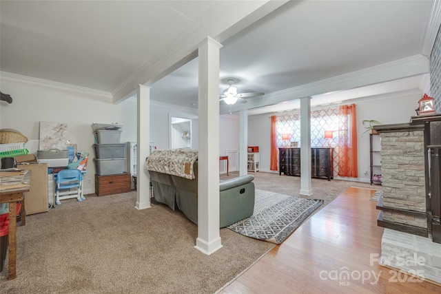 679 Fairforest Rd, Chester, SC 29706 - below grade area with baseboards, a stone fireplace, ornamental molding, ceiling fan, and wood finished floors