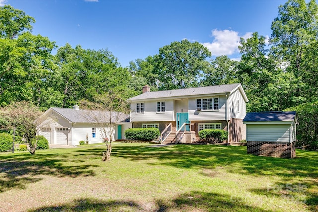 679 Fairforest Rd, Chester, SC 29706 - split foyer home featuring a chimney, a front yard, an outbuilding, and brick siding