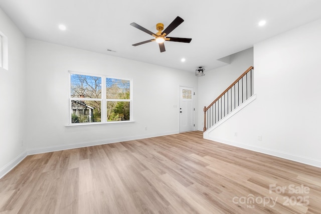 unfurnished living room featuring stairway, light wood-type flooring, ceiling fan, recessed lighting, and baseboards