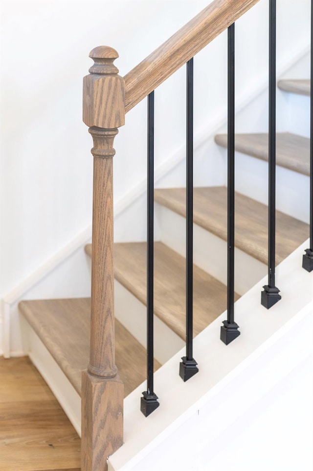 staircase with wood finished floors