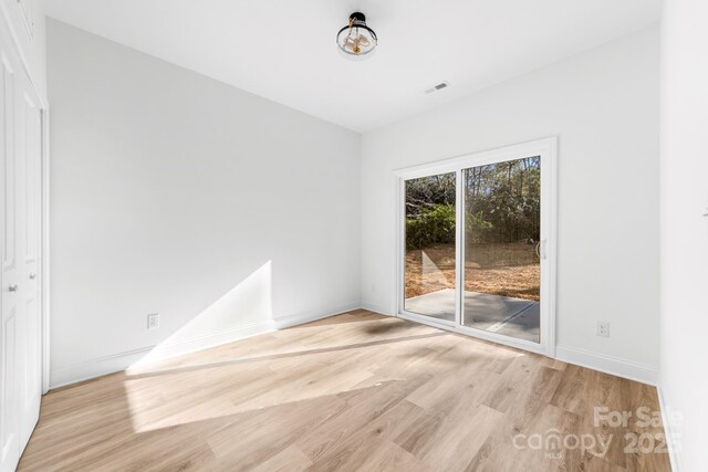 unfurnished room featuring light wood-style flooring and baseboards