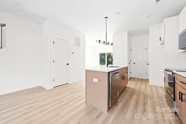 413 Jose St, Shelby, NC 28150 - kitchen featuring a sink, appliances with stainless steel finishes, light wood-style floors, and an island with sink