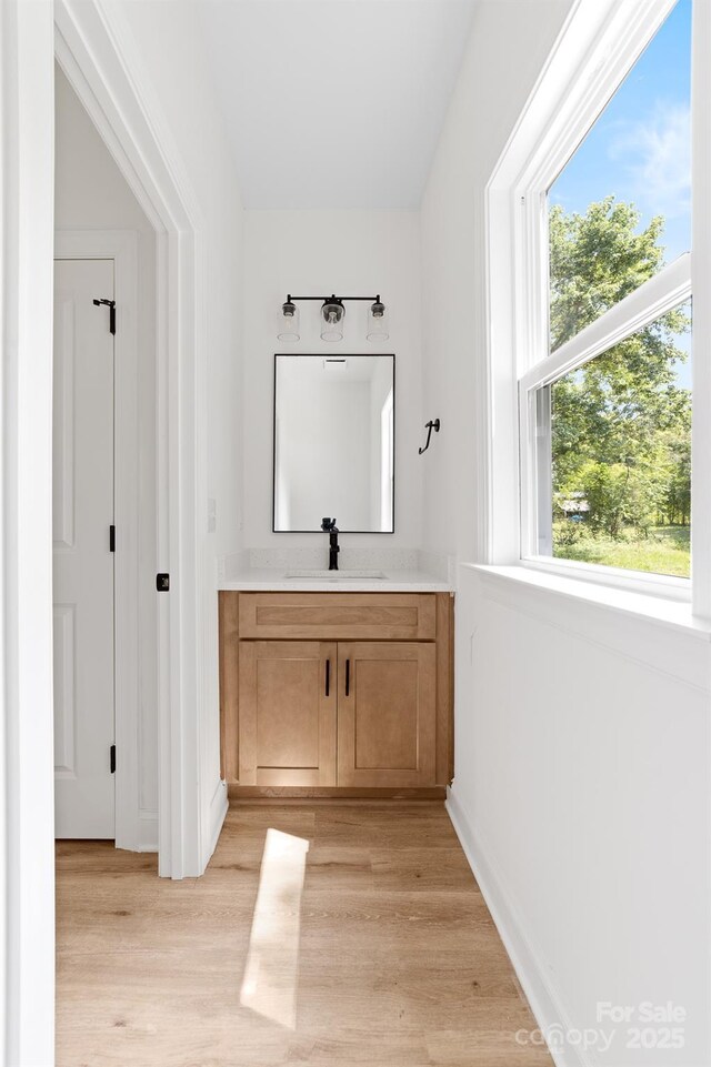 413 Jose St, Shelby, NC 28150 - bathroom featuring vanity, healthy amount of natural light, wood finished floors, and baseboards