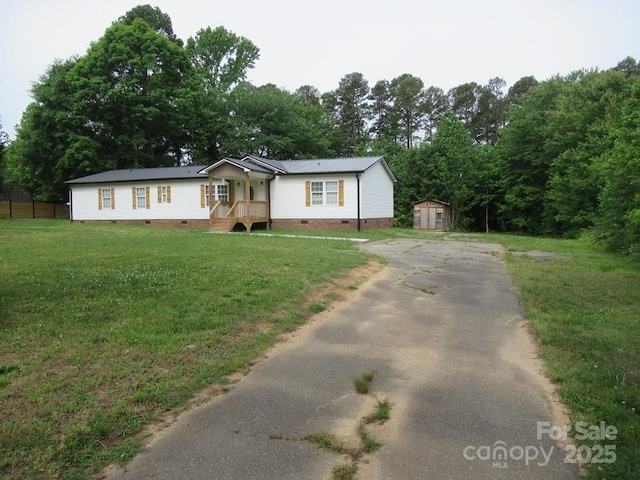 3315 Buffalo Shoals Rd, Newton, NC 28658 - manufactured / mobile home featuring crawl space, asphalt driveway, a shed, an outbuilding, and a front yard