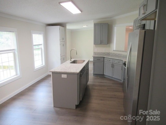 3315 Buffalo Shoals Rd, Newton, NC 28658 - kitchen featuring a sink, freestanding refrigerator, gray cabinetry, an island with sink, and ornamental molding