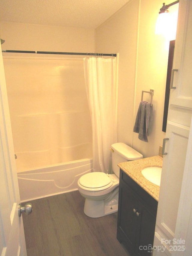 3315 Buffalo Shoals Rd, Newton, NC 28658 - full bathroom featuring wood finished floors, toilet, vanity, shower / bathtub combination with curtain, and a textured ceiling