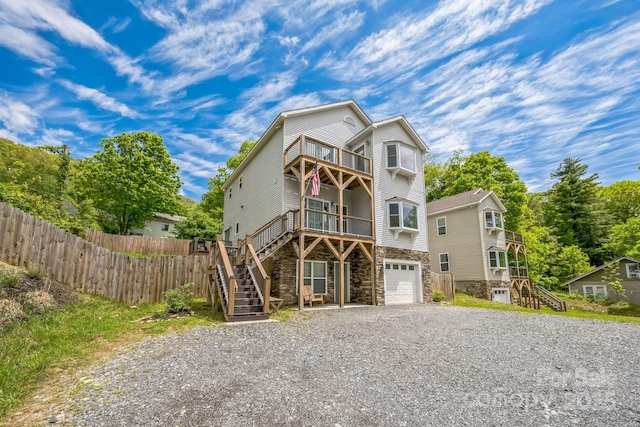274 Old Bristol Rd, Boone, NC 28607 - view of front of home with stairway, stone siding, fence, and gravel driveway