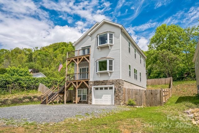 274 Old Bristol Rd, Boone, NC 28607 - view of front of property featuring stone siding, fence, stairs, a balcony, and a garage