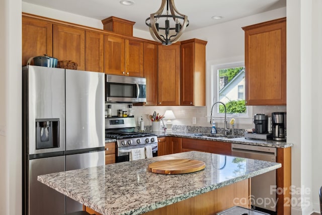 274 Old Bristol Rd, Boone, NC 28607 - kitchen featuring stainless steel appliances, a sink, light stone countertops, backsplash, and brown cabinetry