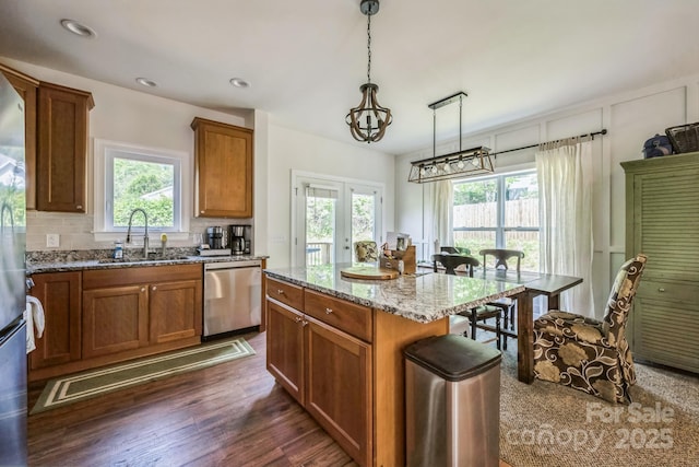 274 Old Bristol Rd, Boone, NC 28607 - kitchen featuring dishwasher, a sink, light stone countertops, brown cabinets, and backsplash