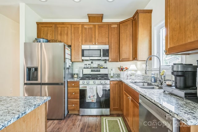 274 Old Bristol Rd, Boone, NC 28607 - kitchen featuring stainless steel appliances, a sink, dark wood-style flooring, light stone countertops, and brown cabinetry