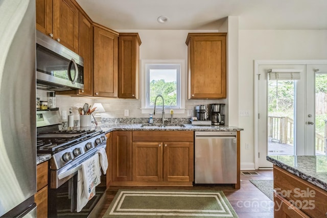 274 Old Bristol Rd, Boone, NC 28607 - kitchen featuring stainless steel appliances, a sink, brown cabinets, and stone countertops