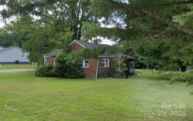 31 Conrad St, Lexington, NC 27295 - view of side of property featuring brick siding and a lawn