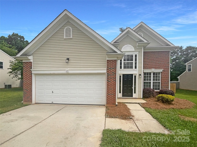traditional home featuring an attached garage, brick siding, and driveway