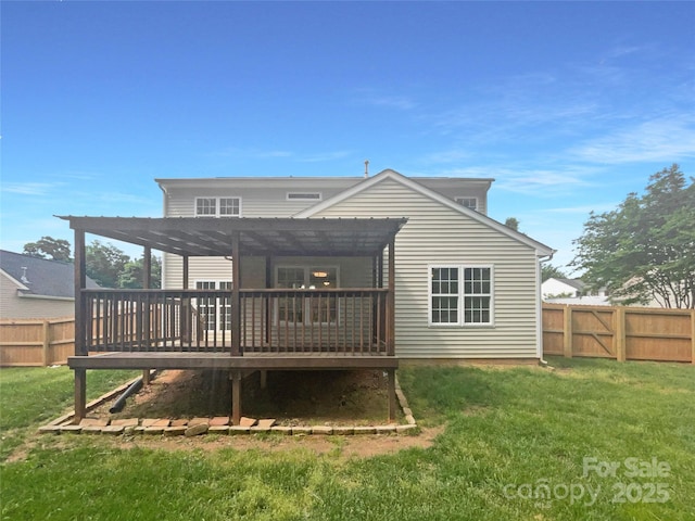 back of property featuring a yard, a wooden deck, a pergola, and a fenced backyard
