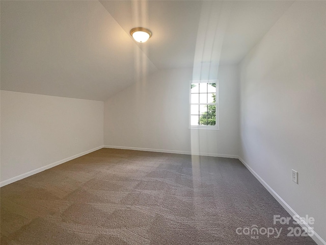bonus room featuring lofted ceiling, baseboards, and carpet