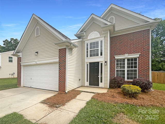 traditional home featuring fence, concrete driveway, a garage, and brick siding