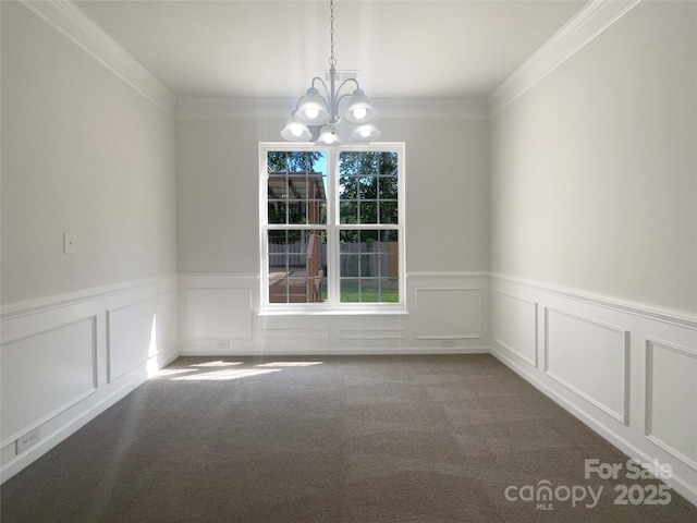 unfurnished dining area with a chandelier, wainscoting, a decorative wall, carpet, and ornamental molding