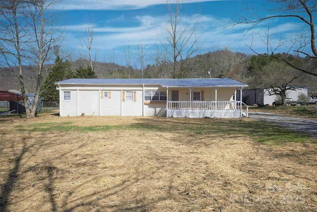 view of front of property with a porch and metal roof