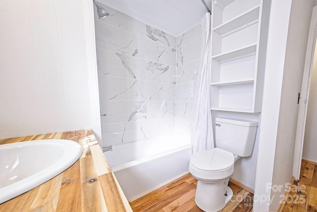 full bathroom with toilet, wood finished floors, a sink, and shower / bathtub combination with curtain