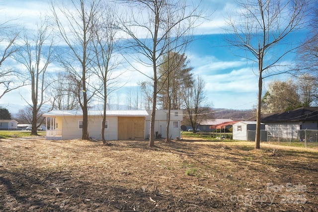 view of yard featuring an outbuilding and fence