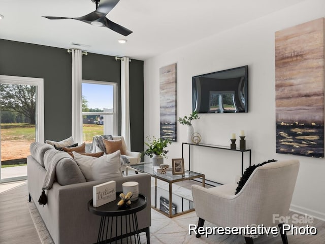 living area with light wood-type flooring, baseboards, ceiling fan, and recessed lighting