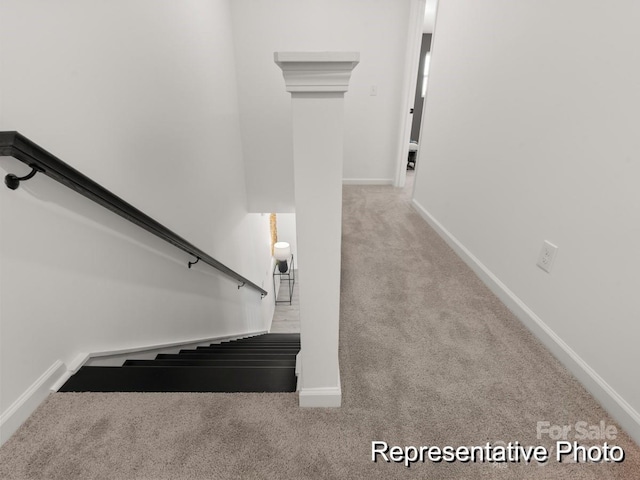 stairway with baseboards and carpet floors