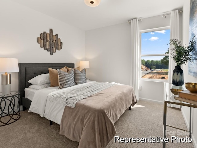 carpeted bedroom with baseboards and multiple windows