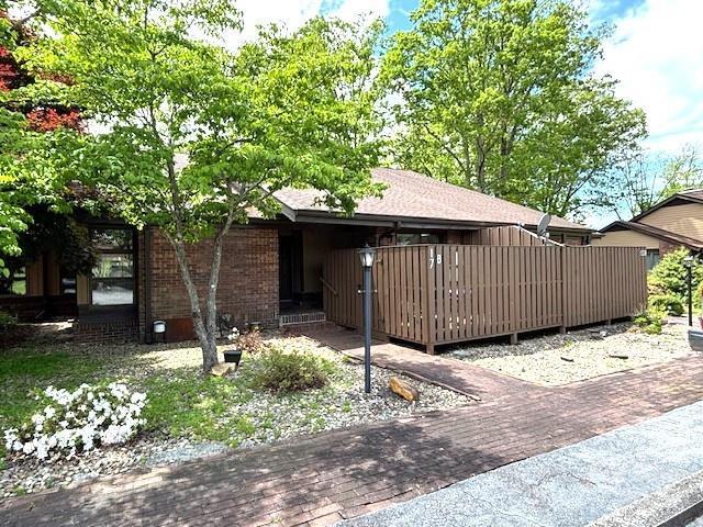 view of side of property featuring brick siding