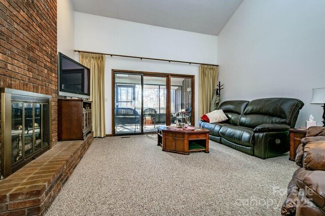 living room featuring carpet and high vaulted ceiling