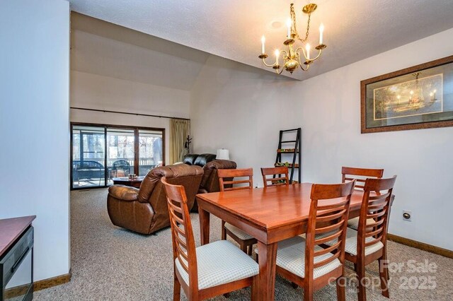 dining room featuring a chandelier, carpet floors, and baseboards