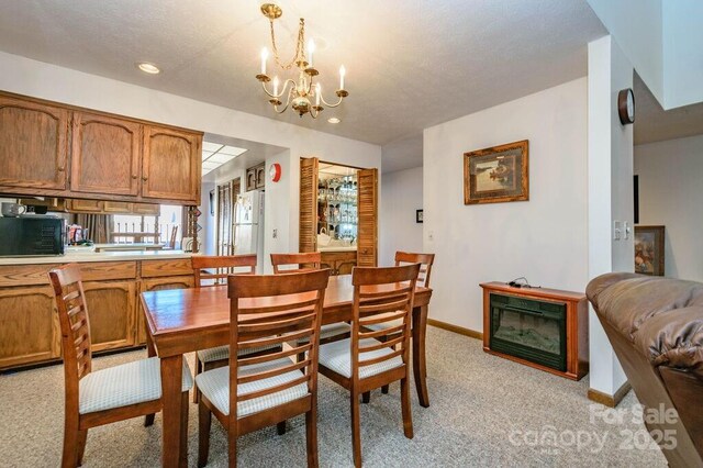 dining space with light colored carpet, a chandelier, recessed lighting, and baseboards