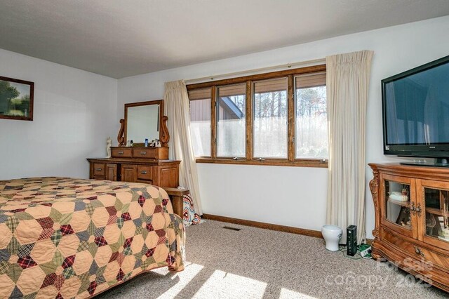 bedroom featuring carpet flooring and baseboards