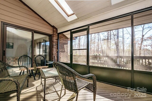 sunroom / solarium featuring vaulted ceiling and a skylight