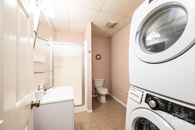 3520 4th Street Blvd NW, Hickory, NC 28601 - full bathroom featuring stacked washing machine and dryer, a shower stall, tile patterned floors, toilet, and vanity