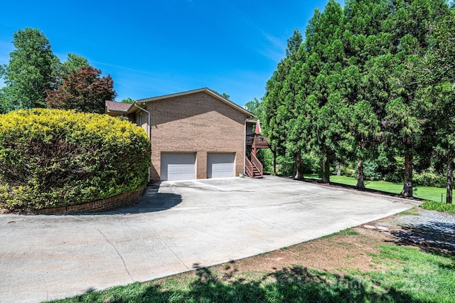 3520 4th Street Blvd NW, Hickory, NC 28601 - view of property exterior with stairway, concrete driveway, brick siding, an attached garage, and a deck