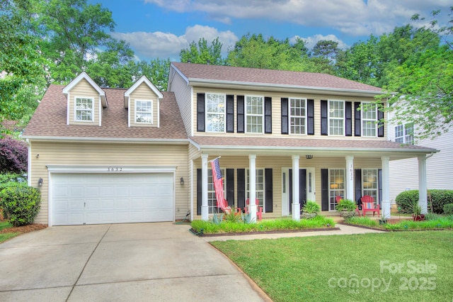 colonial house with covered porch, concrete driveway, a front lawn, a garage, and a shingled roof