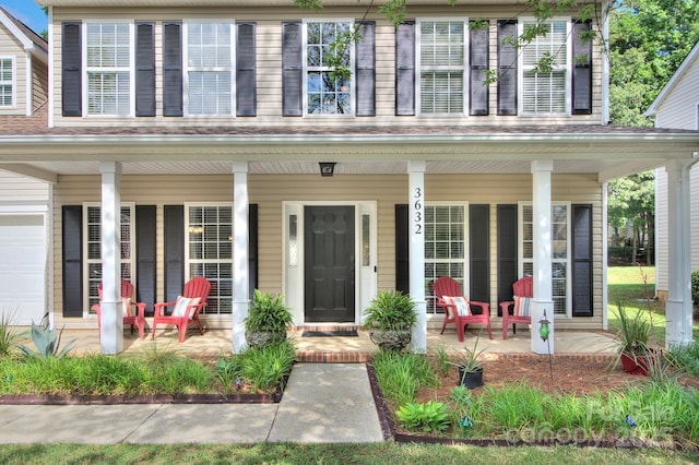 view of exterior entry with covered porch