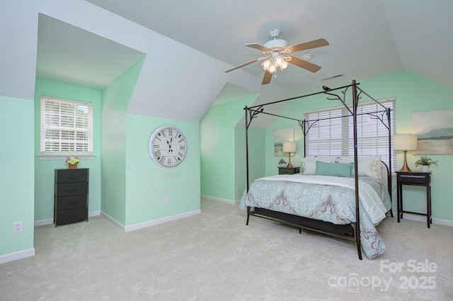 carpeted bedroom with vaulted ceiling, baseboards, and a ceiling fan