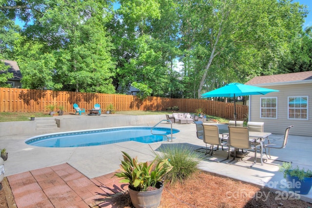 view of pool with a patio, a fenced backyard, and outdoor dining space