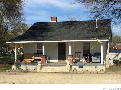 exterior space featuring a porch and a chimney