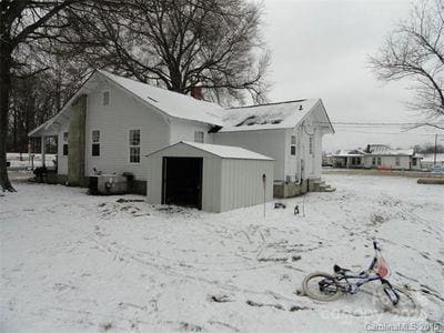 exterior space featuring an outbuilding and a shed