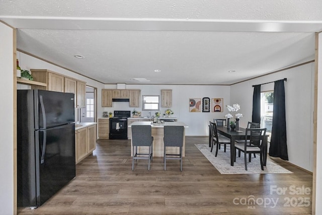 104 Advent Dr, Grover, NC 28073 - kitchen with black appliances, light countertops, dark wood-type flooring, light brown cabinetry, and a kitchen island