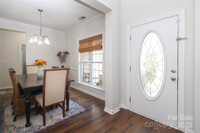 10217 Falling Leaf Dr, Concord, NC 28027 - foyer entrance with healthy amount of natural light, dark wood-style floors, crown molding, a chandelier, and baseboards