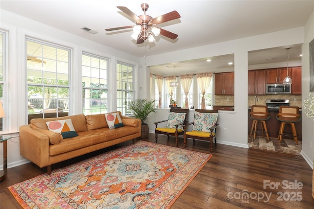 10217 Falling Leaf Dr, Concord, NC 28027 - living area with ceiling fan, dark wood-style flooring, and baseboards