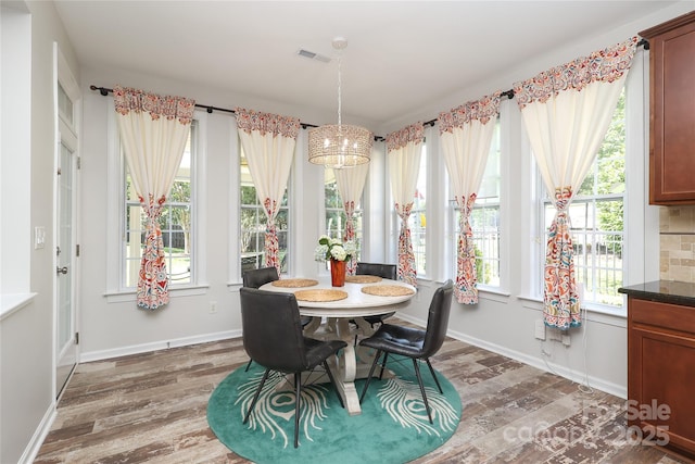 10217 Falling Leaf Dr, Concord, NC 28027 - dining space with wood finished floors, baseboards, and a chandelier