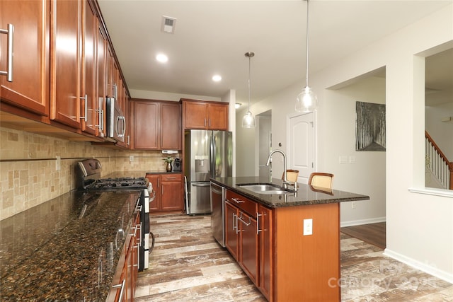 10217 Falling Leaf Dr, Concord, NC 28027 - kitchen with appliances with stainless steel finishes, a sink, backsplash, dark stone counters, and recessed lighting